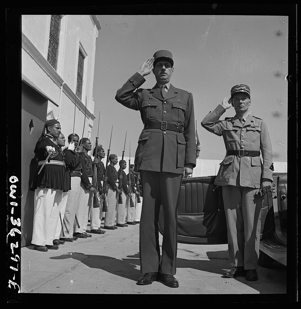 Carthage, Tunisia. General de Gaulle, accompanied by General Mast, saluting as the band plays Marseillaise outside the s