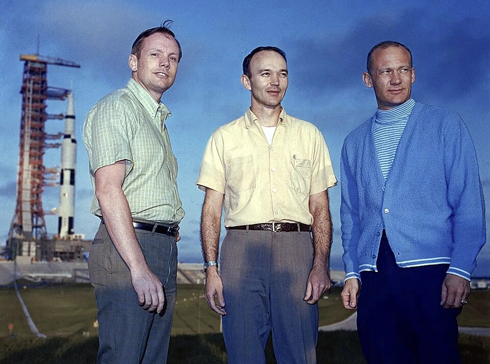 Apollo 11 astronauts pose with their Saturn V rocket